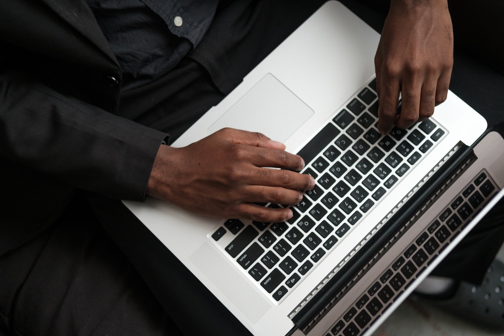 Man Typing on Laptop